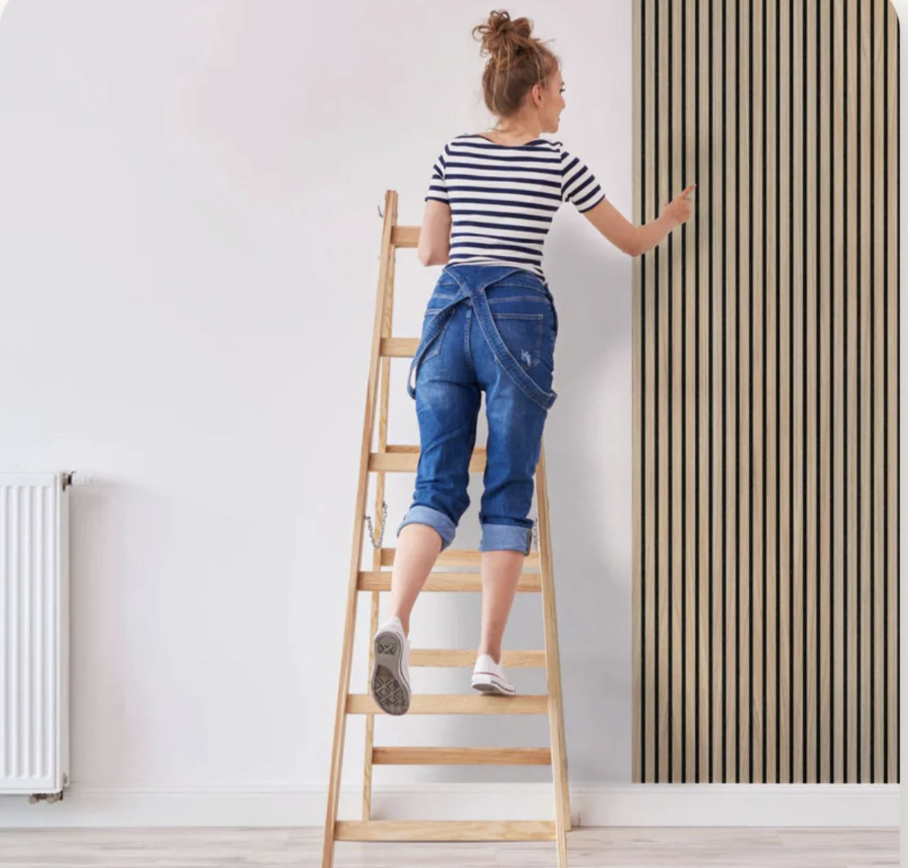 Woman on a ladder installing the panel
